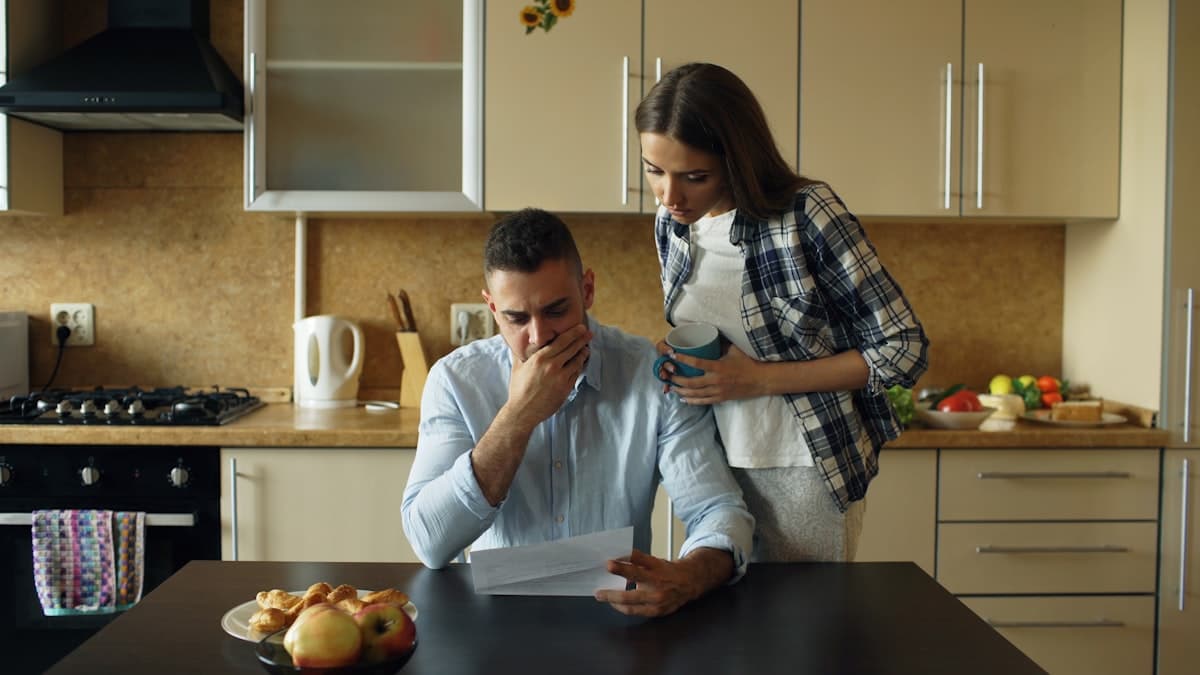 Couple looking worried while reading a rent increase letter